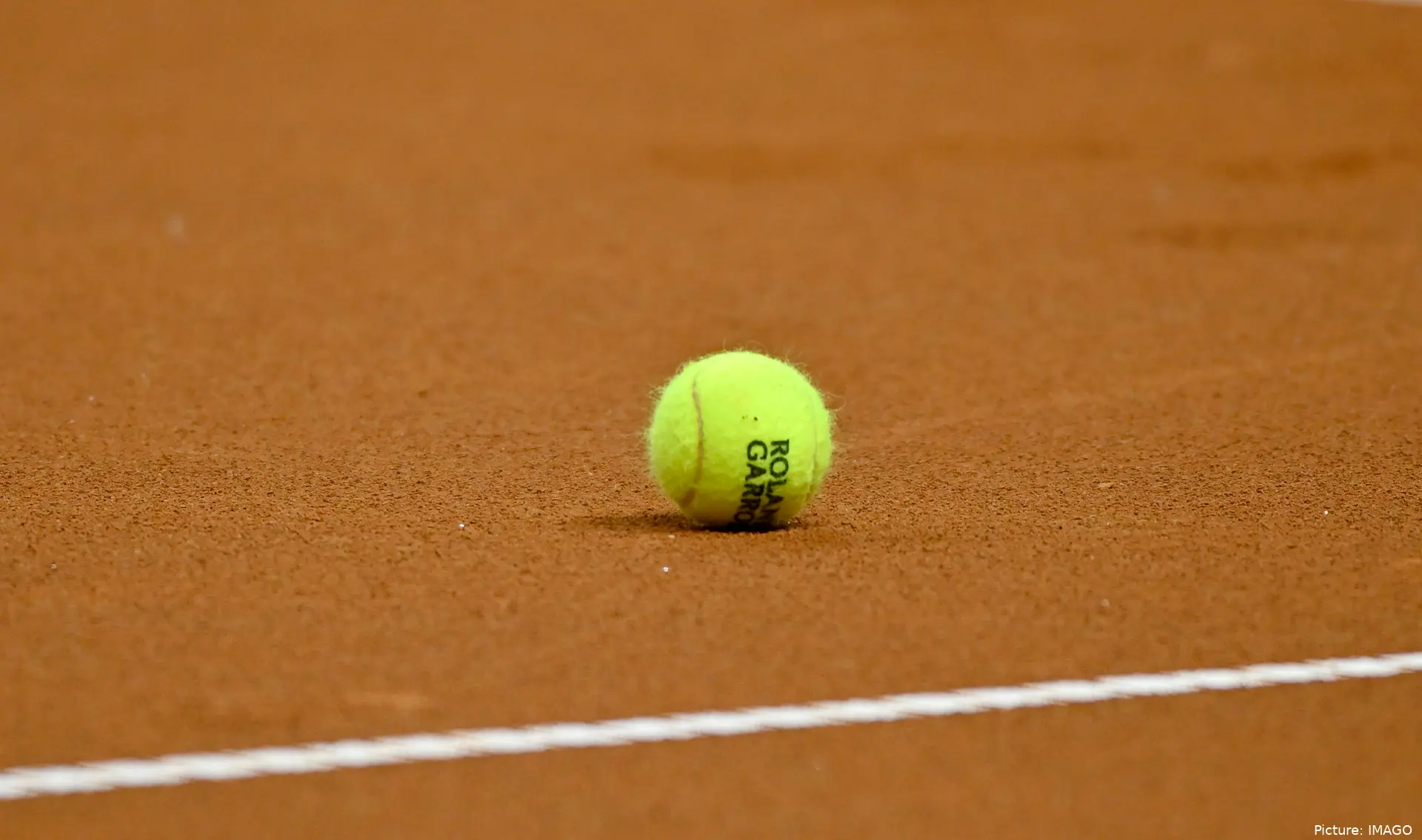 Tennis ball on clay surface