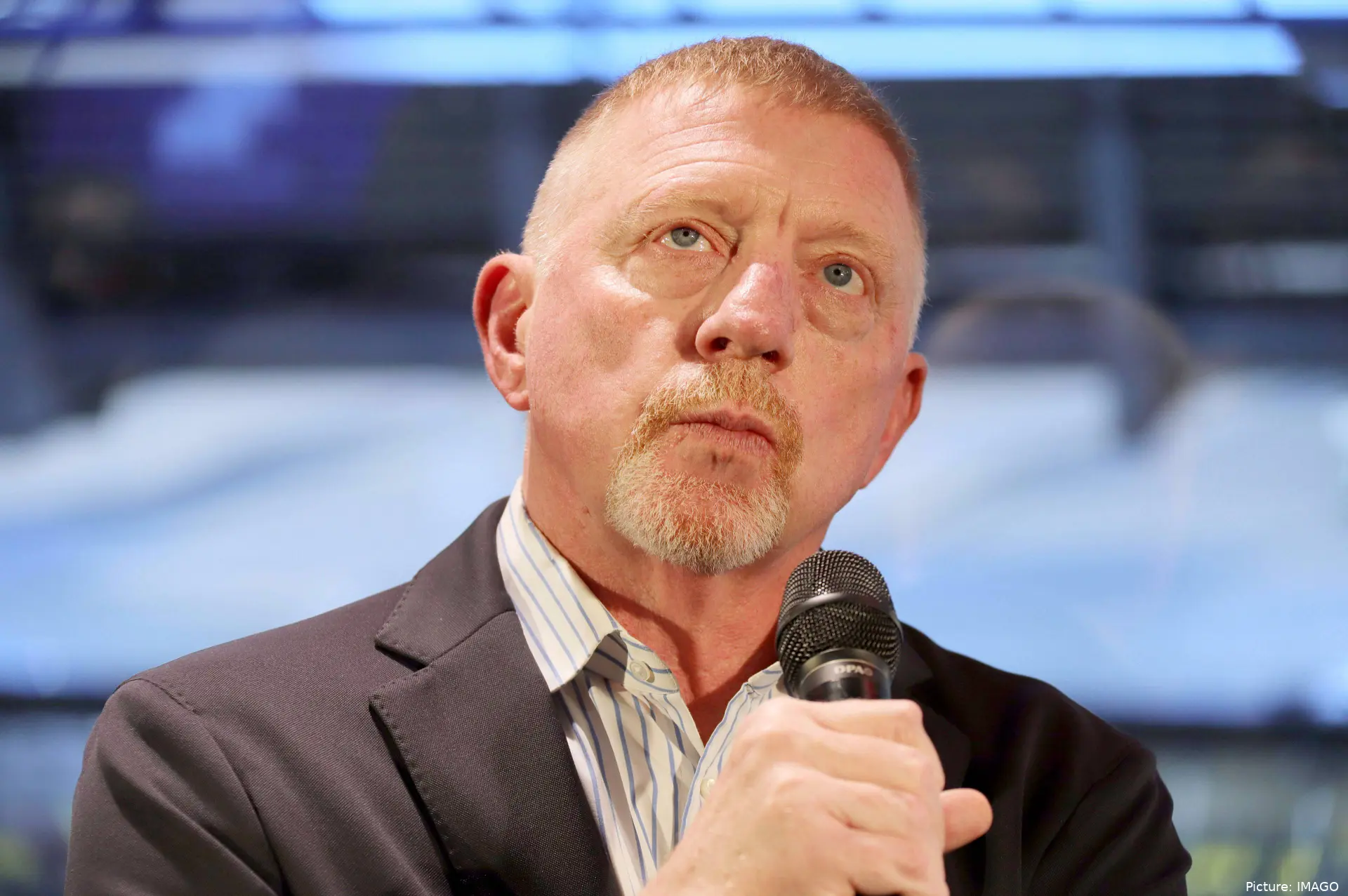 Boris Becker with a microphone in his hand