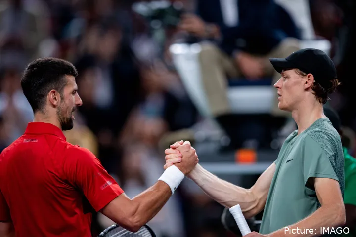 Jannik Sinner and Novak Djokovic shaking hands at the net