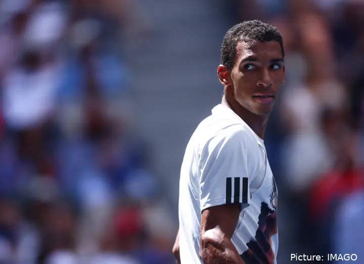 Felix Auger-Aliassime looks over his shoulder