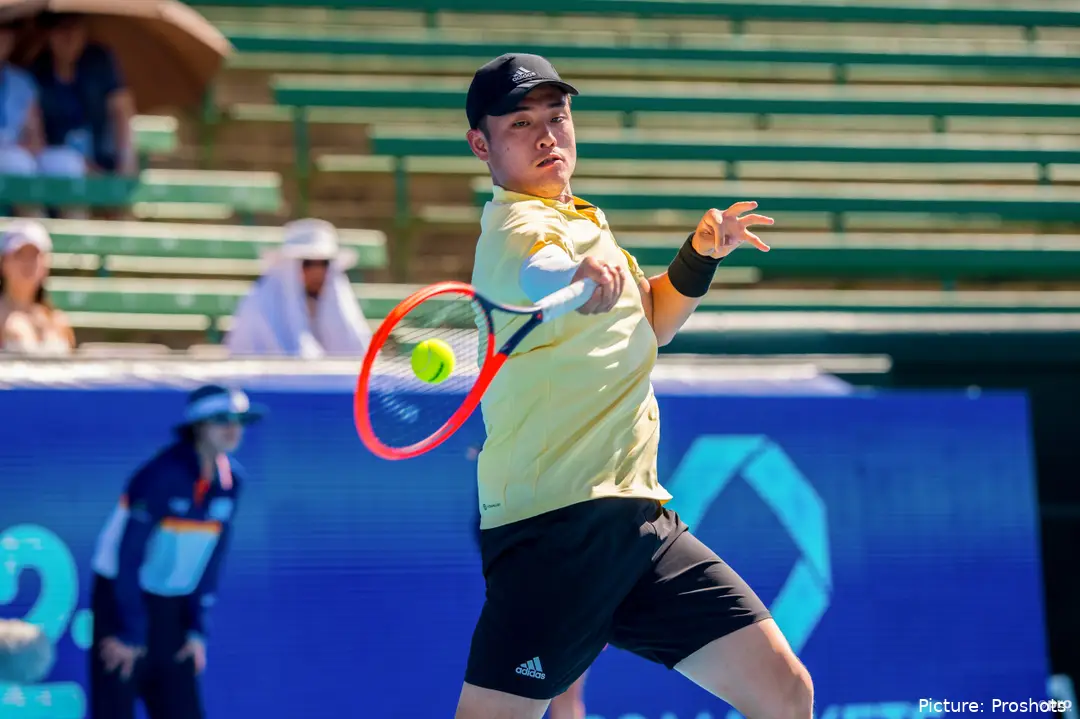 Wu Yibing hitting a forehand.