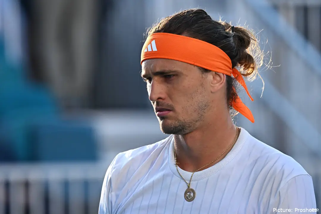 Alexander Zverev looks on.