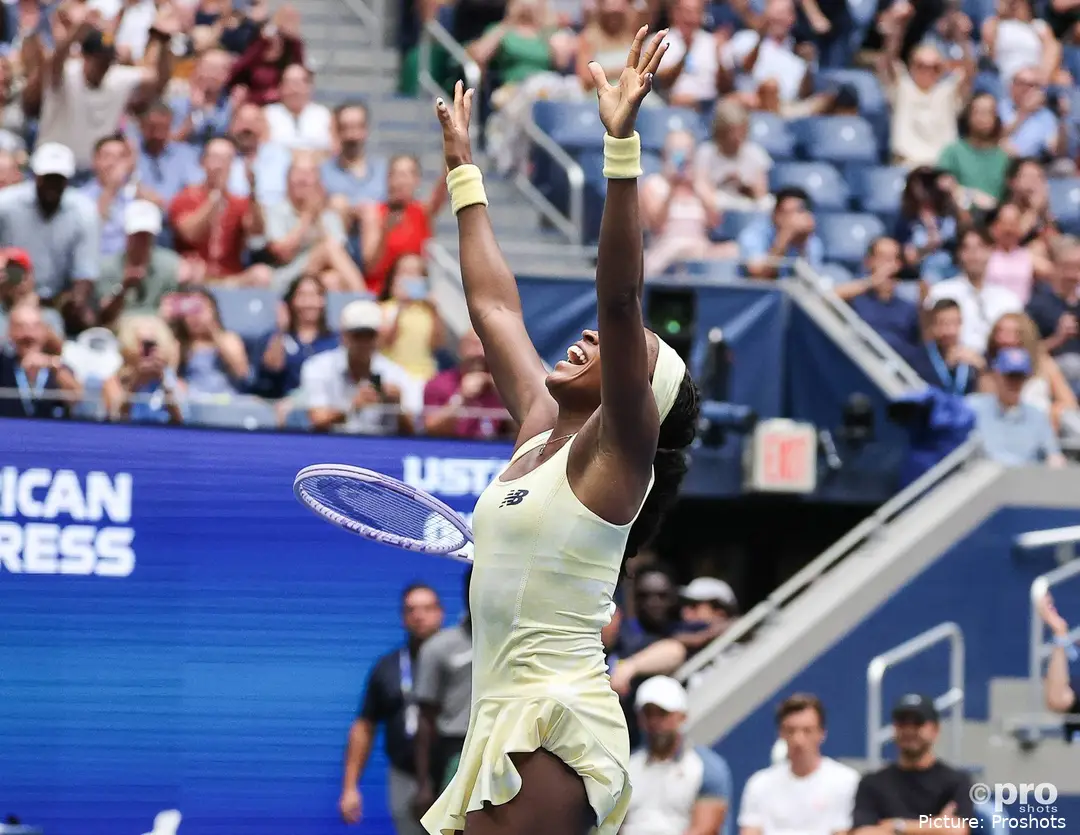 Coco Gauff raises her arms after defeating Mirra Andreeva in the US Open quarterfinals.