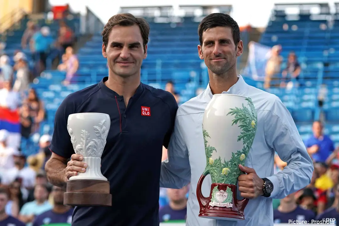 Novak Djokovic and Roger Federer holding their trophies after the 2018 Cincinnati Open final.