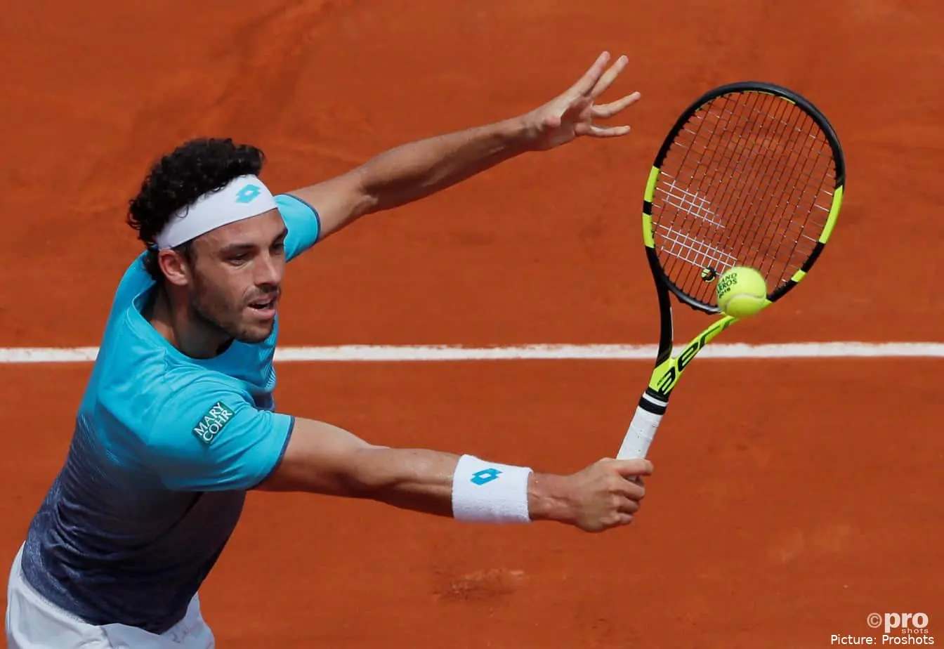 Marco Cecchinato hitting the ball with his racket at Roland Garros 2018