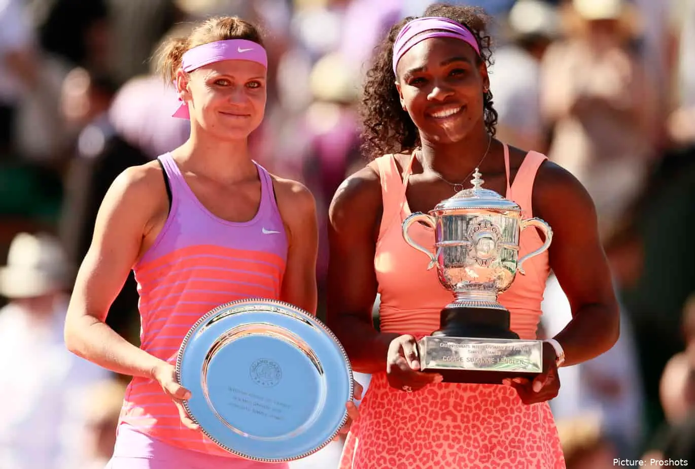 Serena Williams holding the champion's trophy at the 2015 French Open alongside runner-up Lucie Safarova