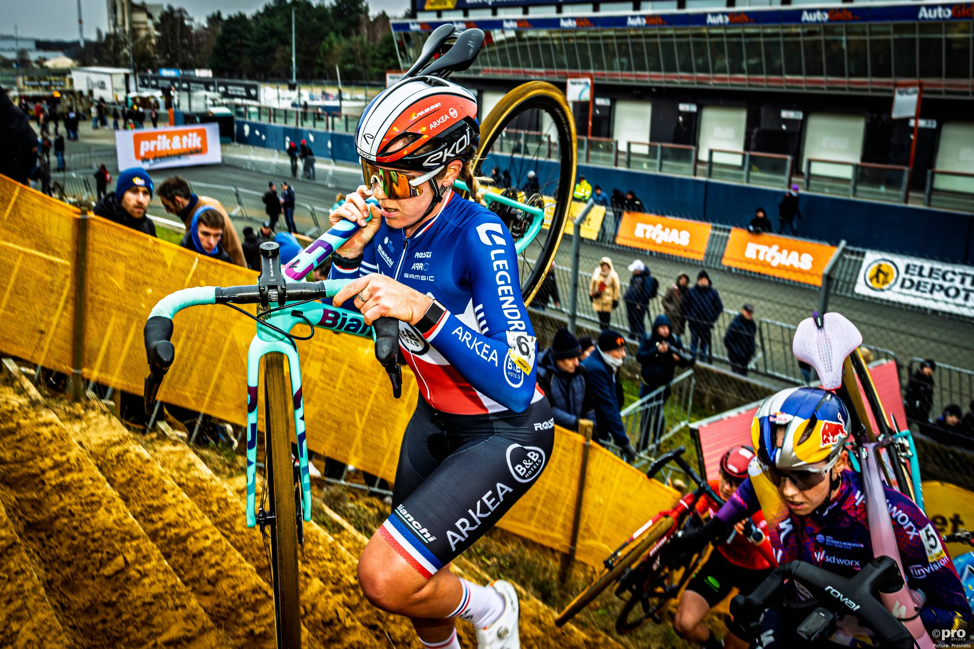 Amandine Fouquenet running up stairs during a cyclocross race