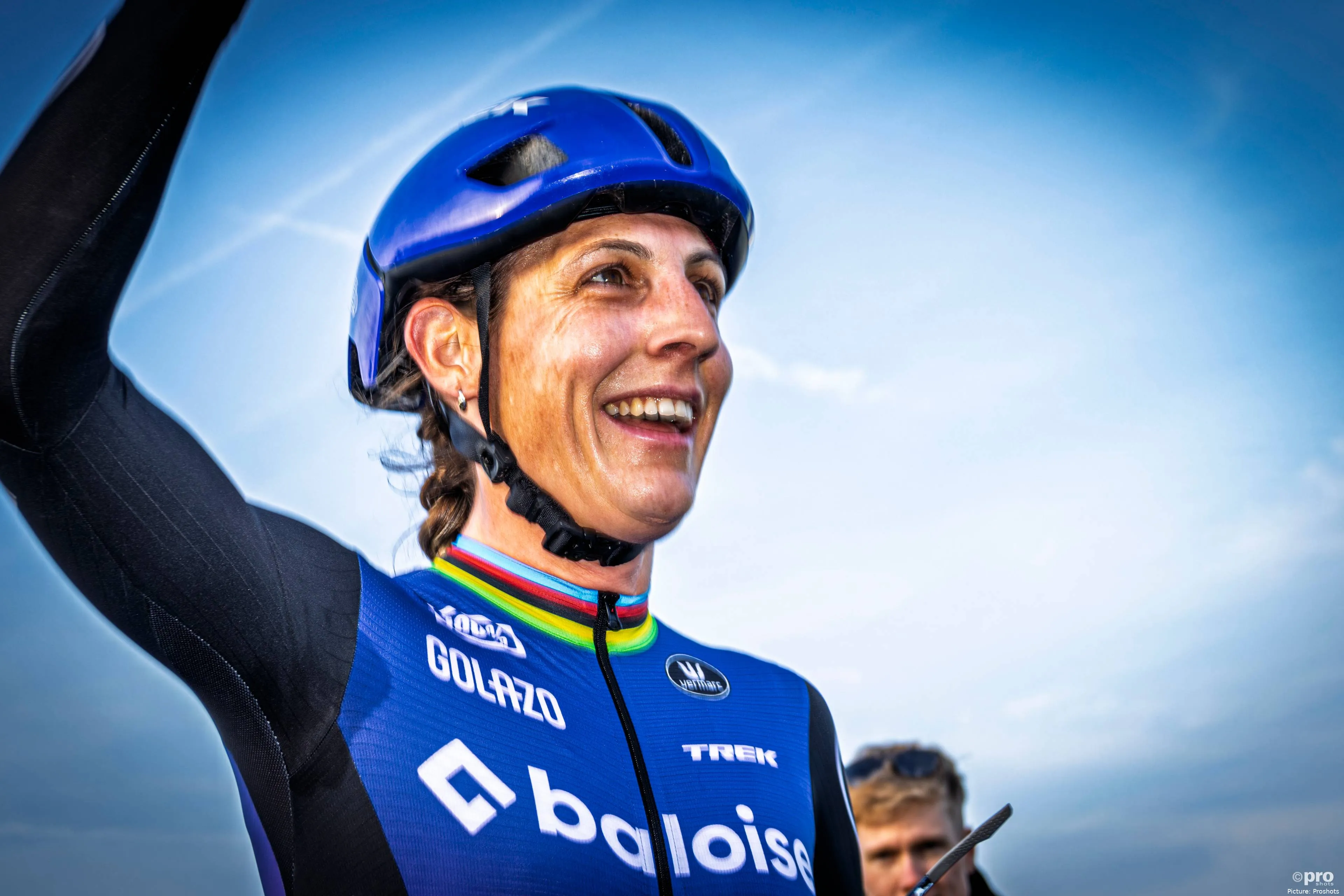 Lucinda Brand raising her arm and smiling after winning during the 2025-2026 cyclocross season