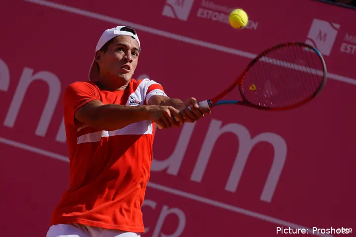 Sebastian Baez hits with his backhand