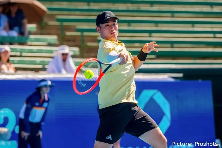 Wu Yibing hitting a forehand.