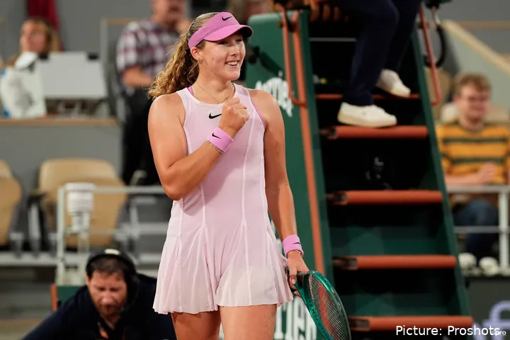 Mirra Andreeva smiling while fist pumping on court