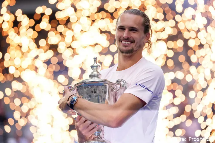Alexander Zverev holding trophy while smiling