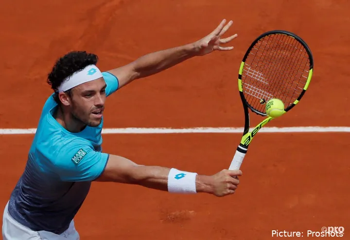 Marco Cecchinato hitting the ball with his racket at Roland Garros 2018