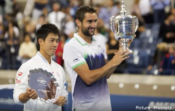 Cilici holds his US Open champion's trophy alongside runner-up Kei Nishikori