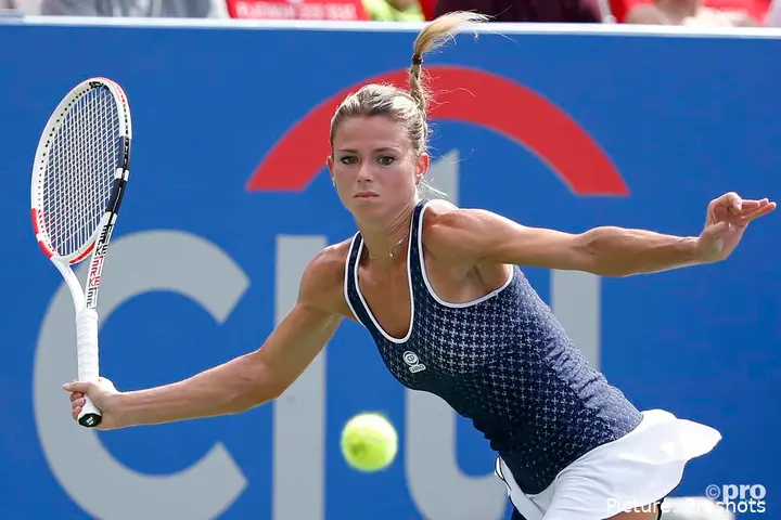 Camila Giorgi returns shot.