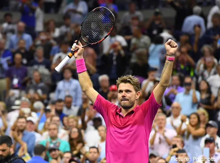 Wawirnka raises both arms celebrating a victory on his run at the 2016 US Open