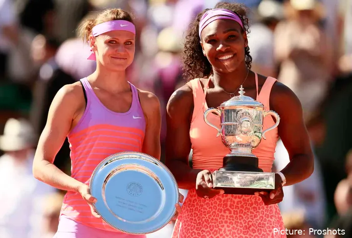 Serena Williams holding the champion's trophy at the 2015 French Open alongside runner-up Lucie Safarova