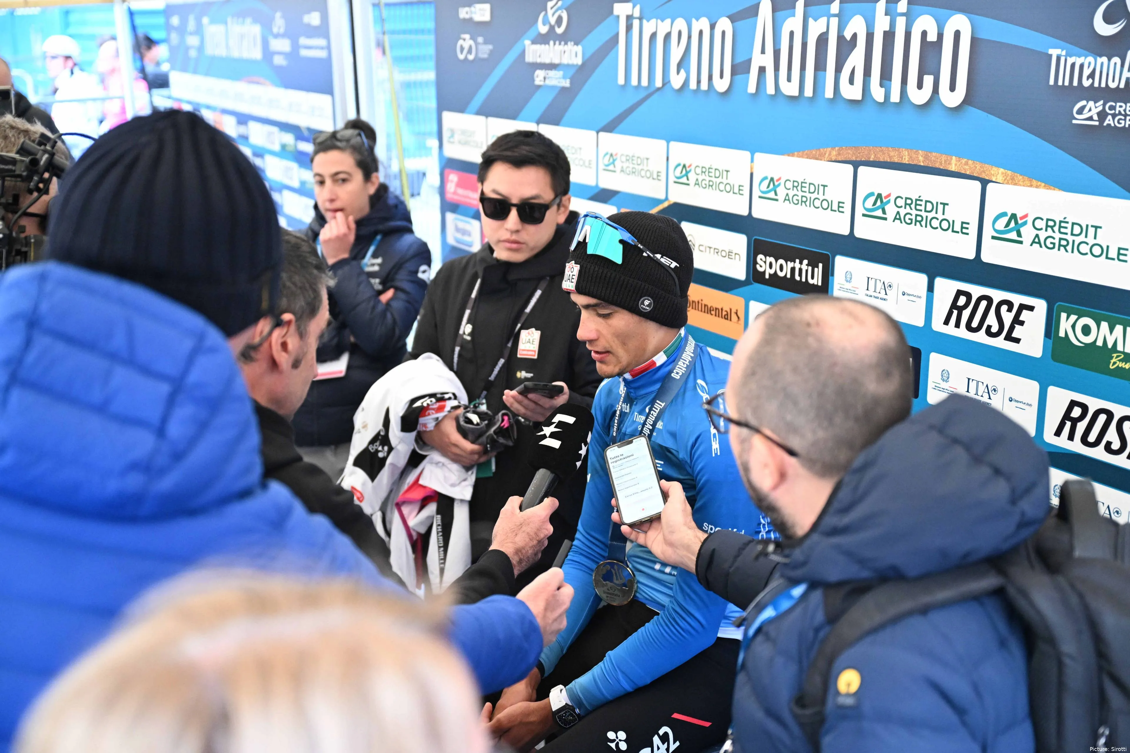 Isaac del Toro surrounded by media during an interview at Tirreno-Adriatico 2026