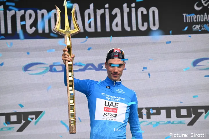 Juan Ayuso celebrates with Tirreno-Adriatico's unique trident trophy after his GC win in 2025