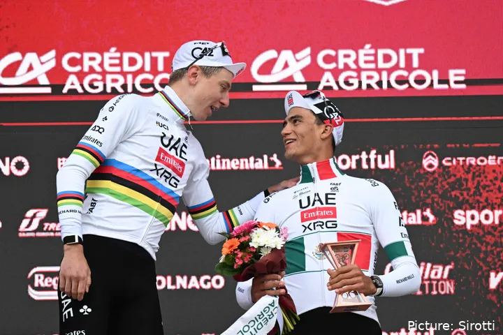 Tadej Pogacar and Isaac del Toro embrace on the podium after Strade Bianche 2026