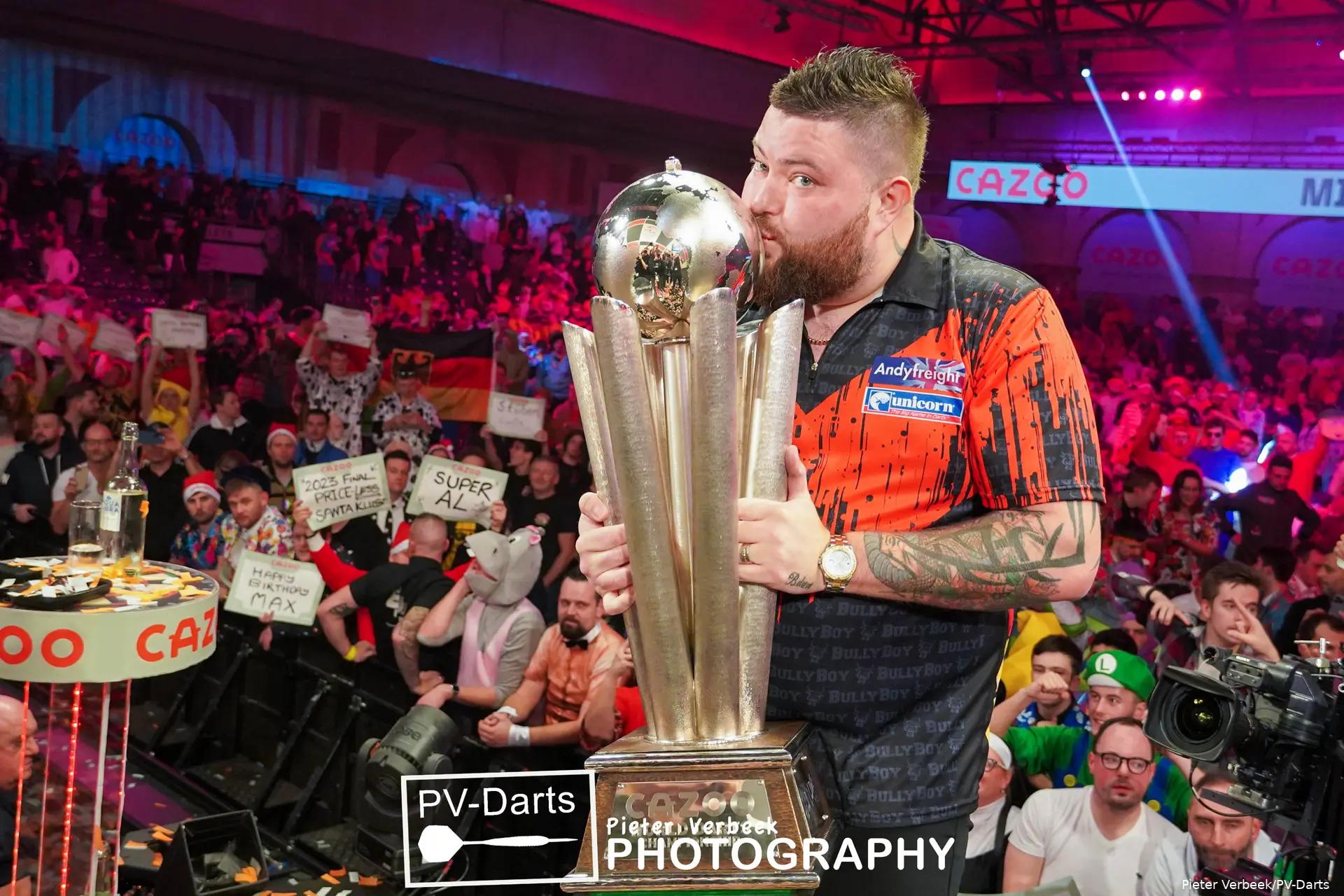 Michael Smith is kissing the Cup because he won the PDC World Darts Championship