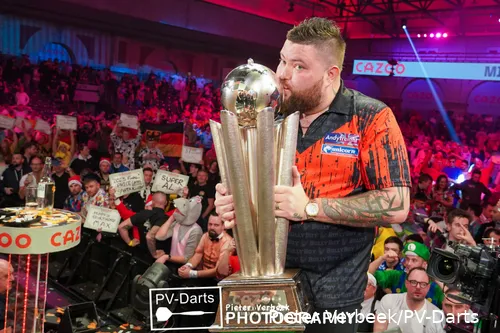 Michael Smith is kissing the Cup because he won the PDC World Darts Championship