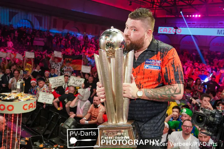 Michael Smith is kissing the Cup because he won the PDC World Darts Championship