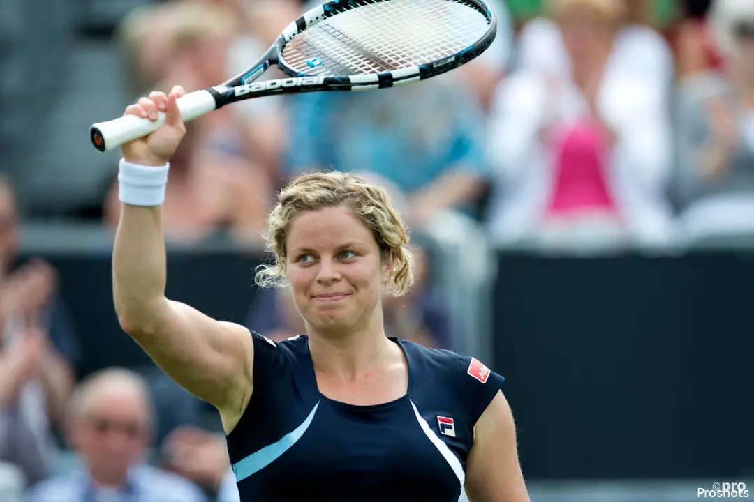Kim Clijsters waves racquet.