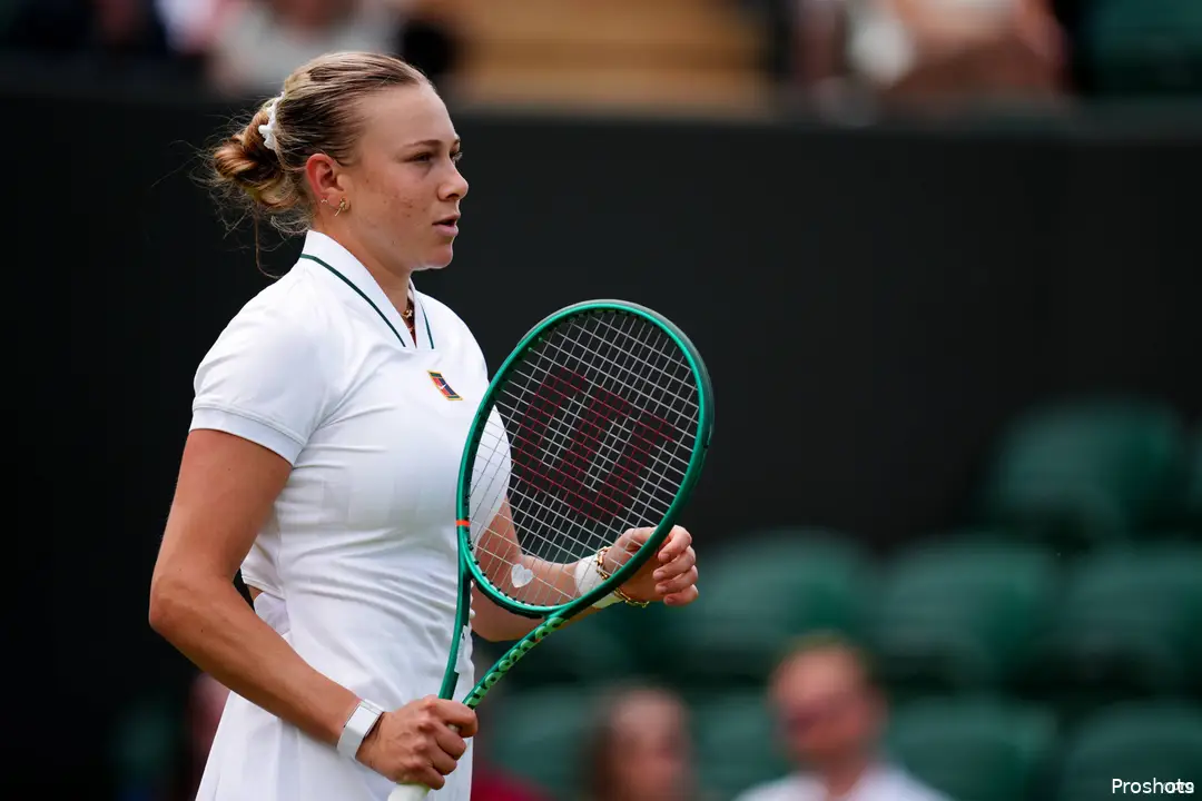 Anisimova looks on.