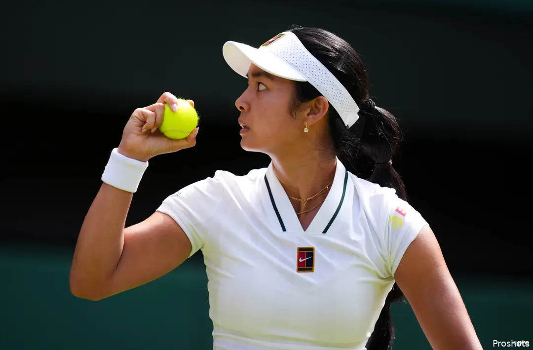 Alexandra Eala holds ball.
