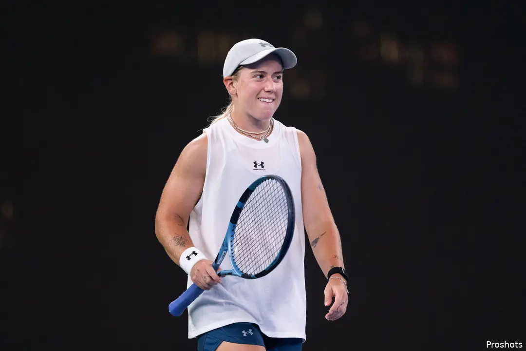 Kartal holds racquet.
