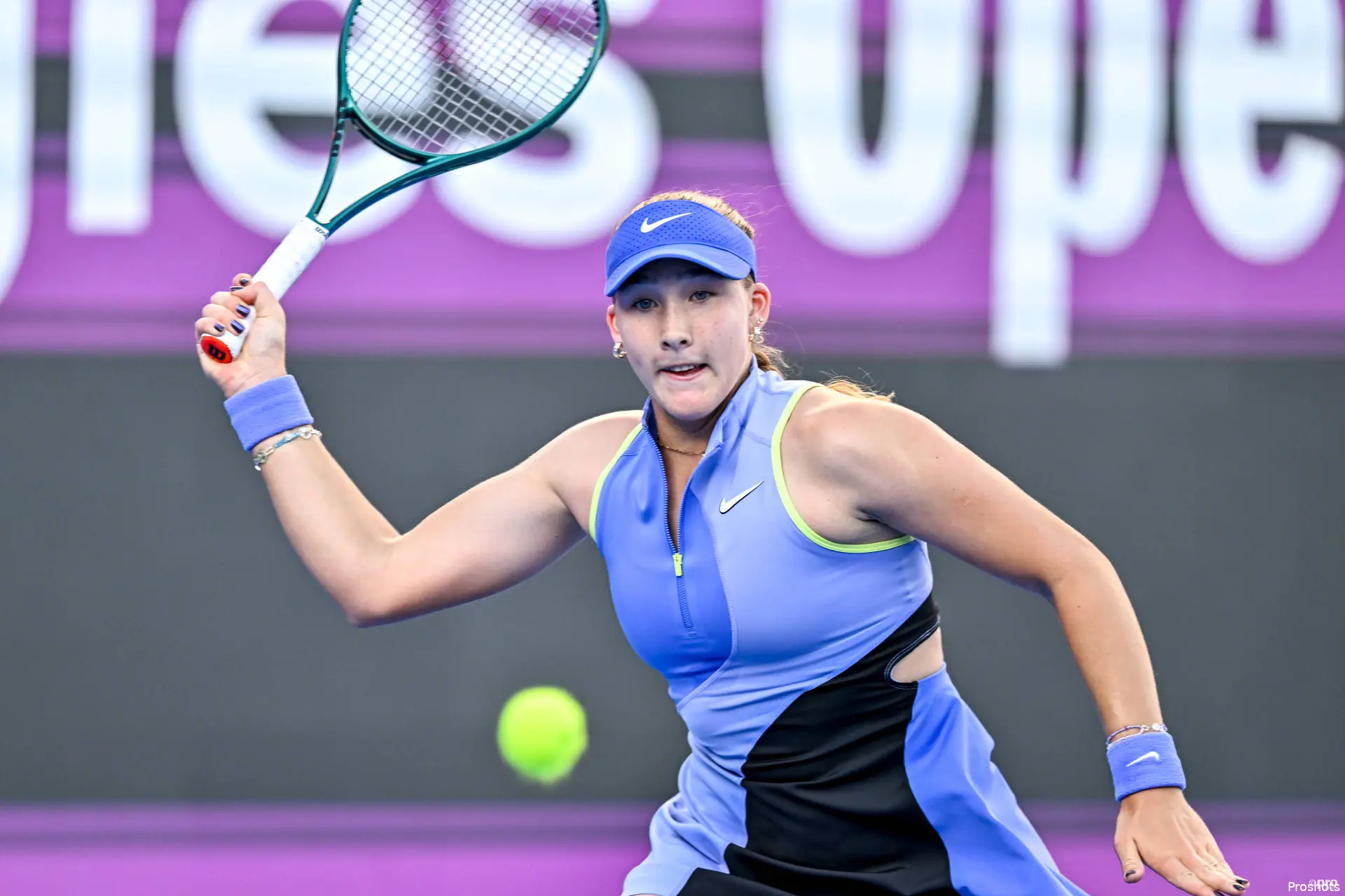 Mirra Andreeva swats return.