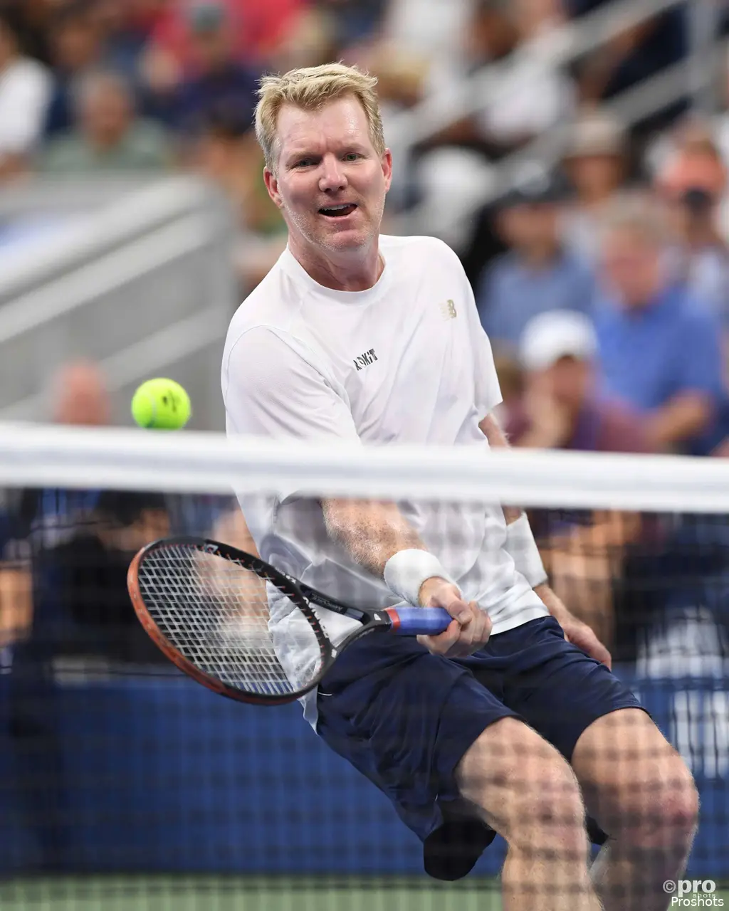 Jim Courier returns shot.