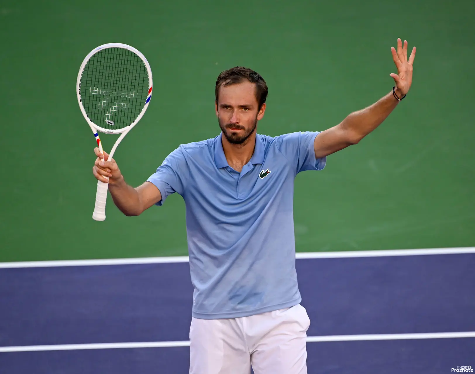 Medvedev waves racquet.
