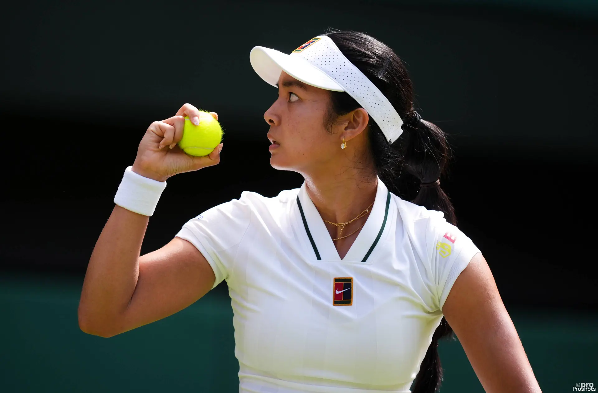 Alexandra Eala holds ball.