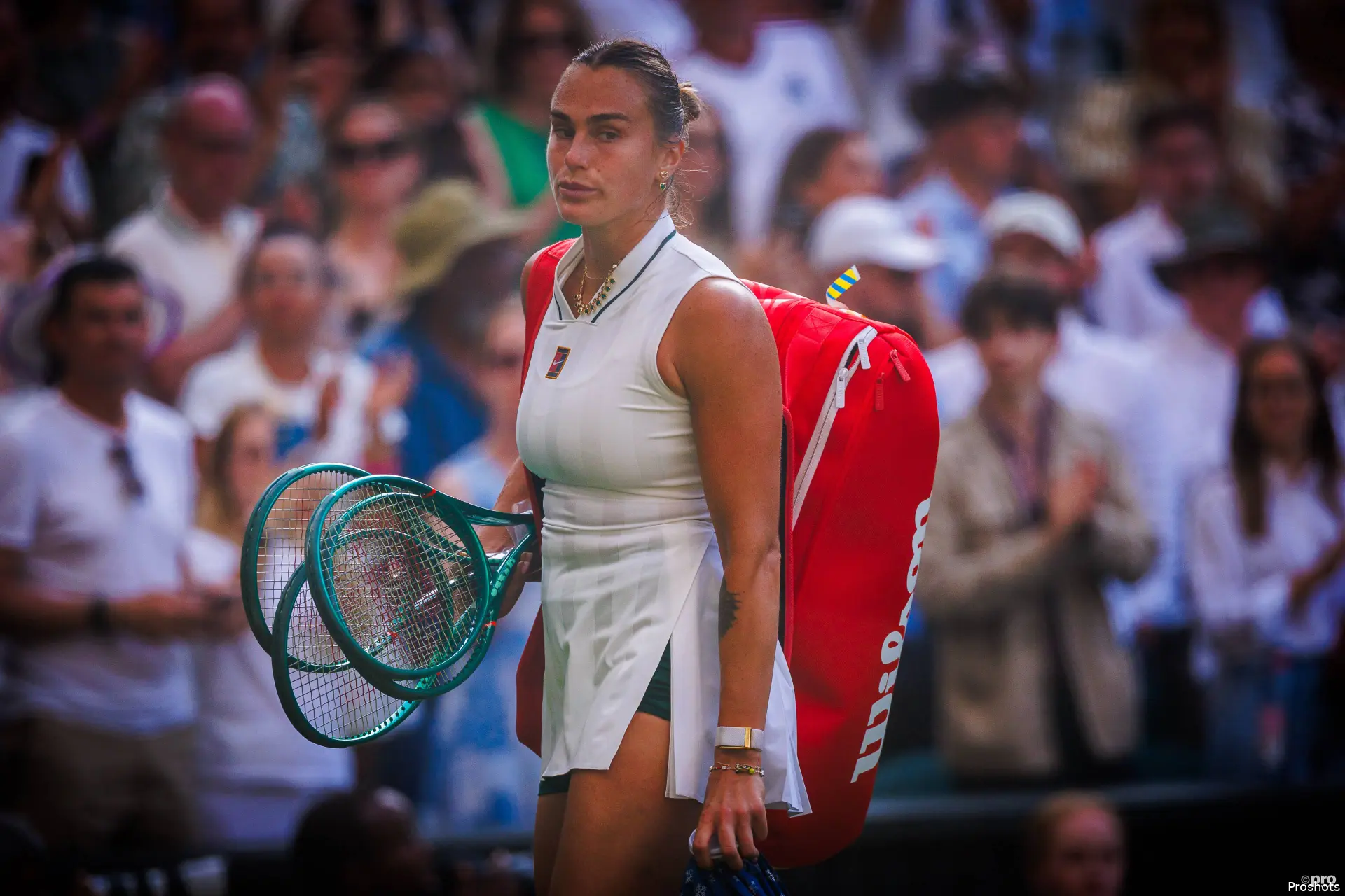 Aryna Sabalenka leaves court after defeat.