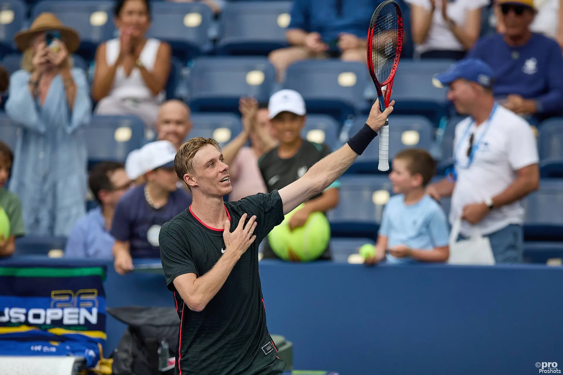 Denis Shapovalov holding his racket up