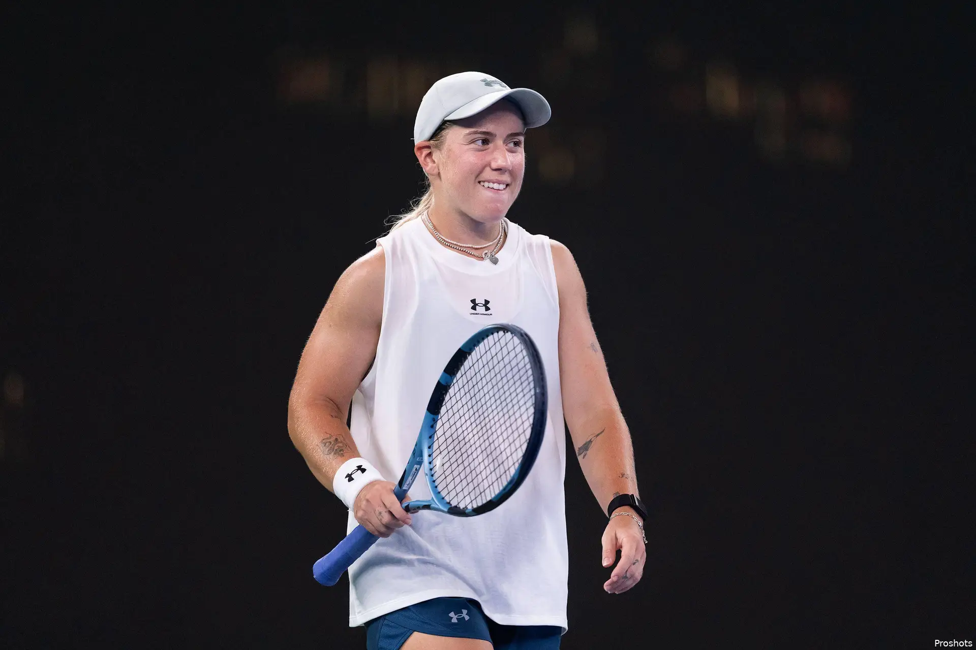 Kartal holds racquet.