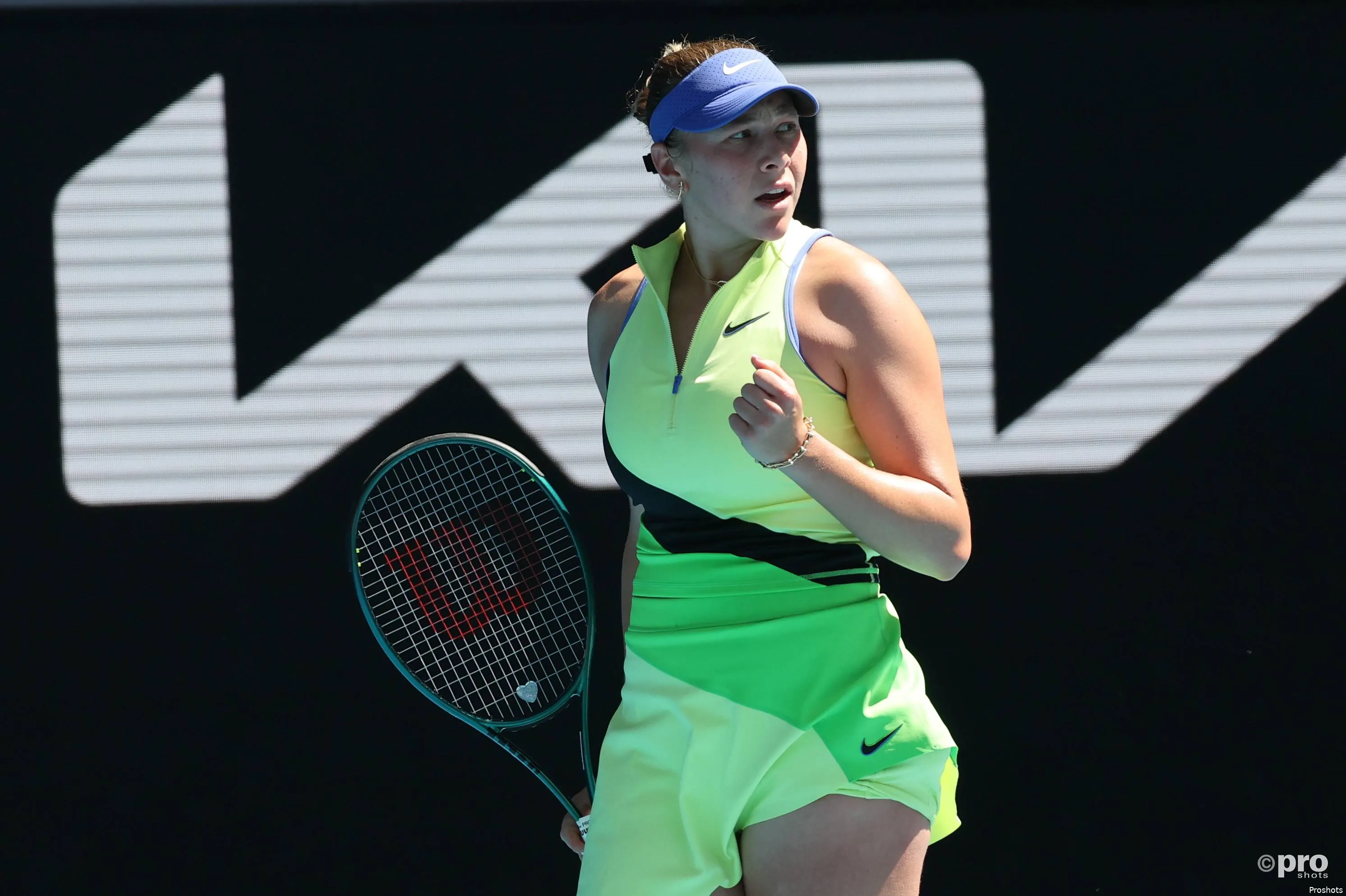 Amanda Anisimova fist pumps after winning point.