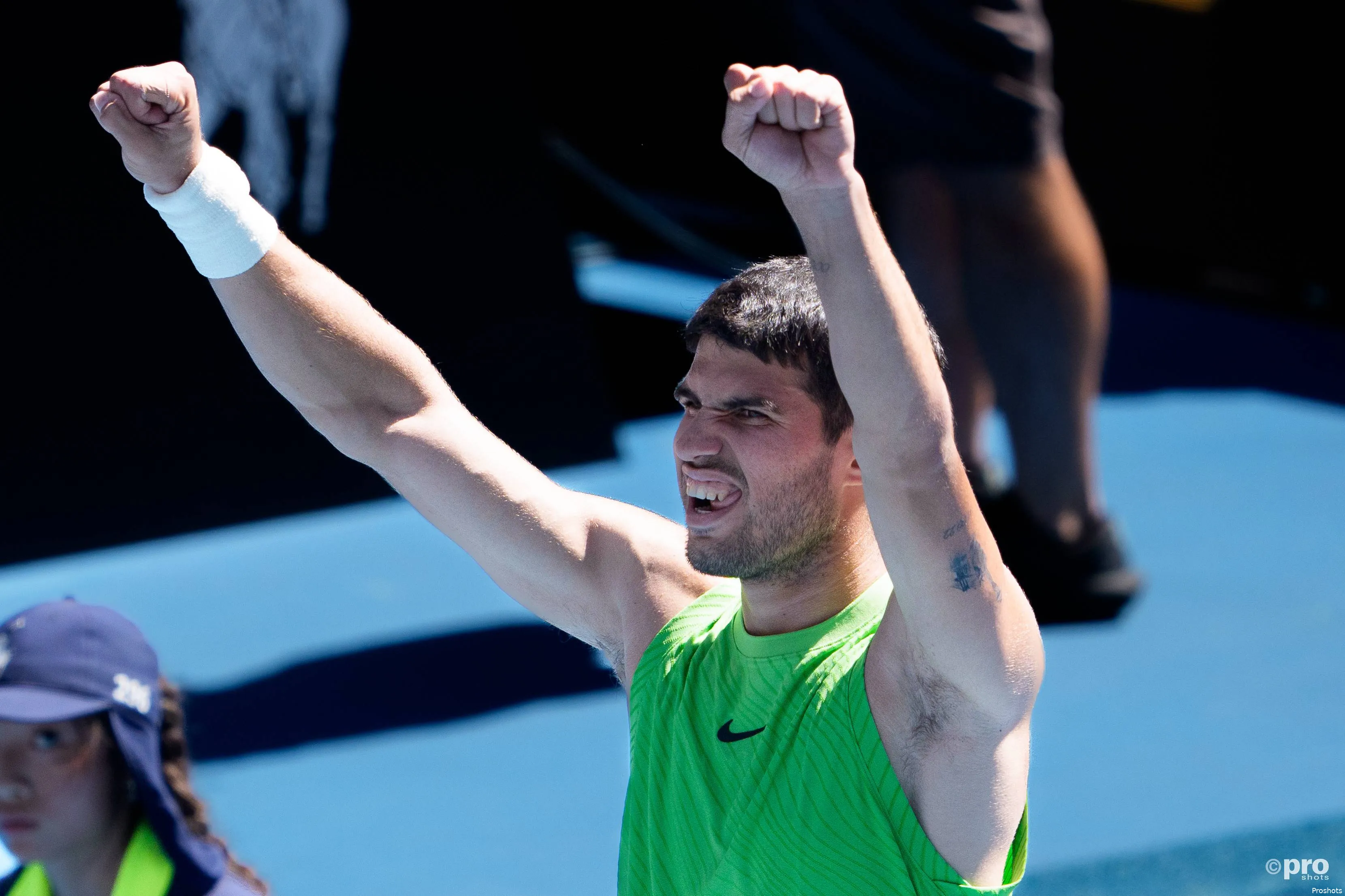 Carlos Alcaraz raises both fists.