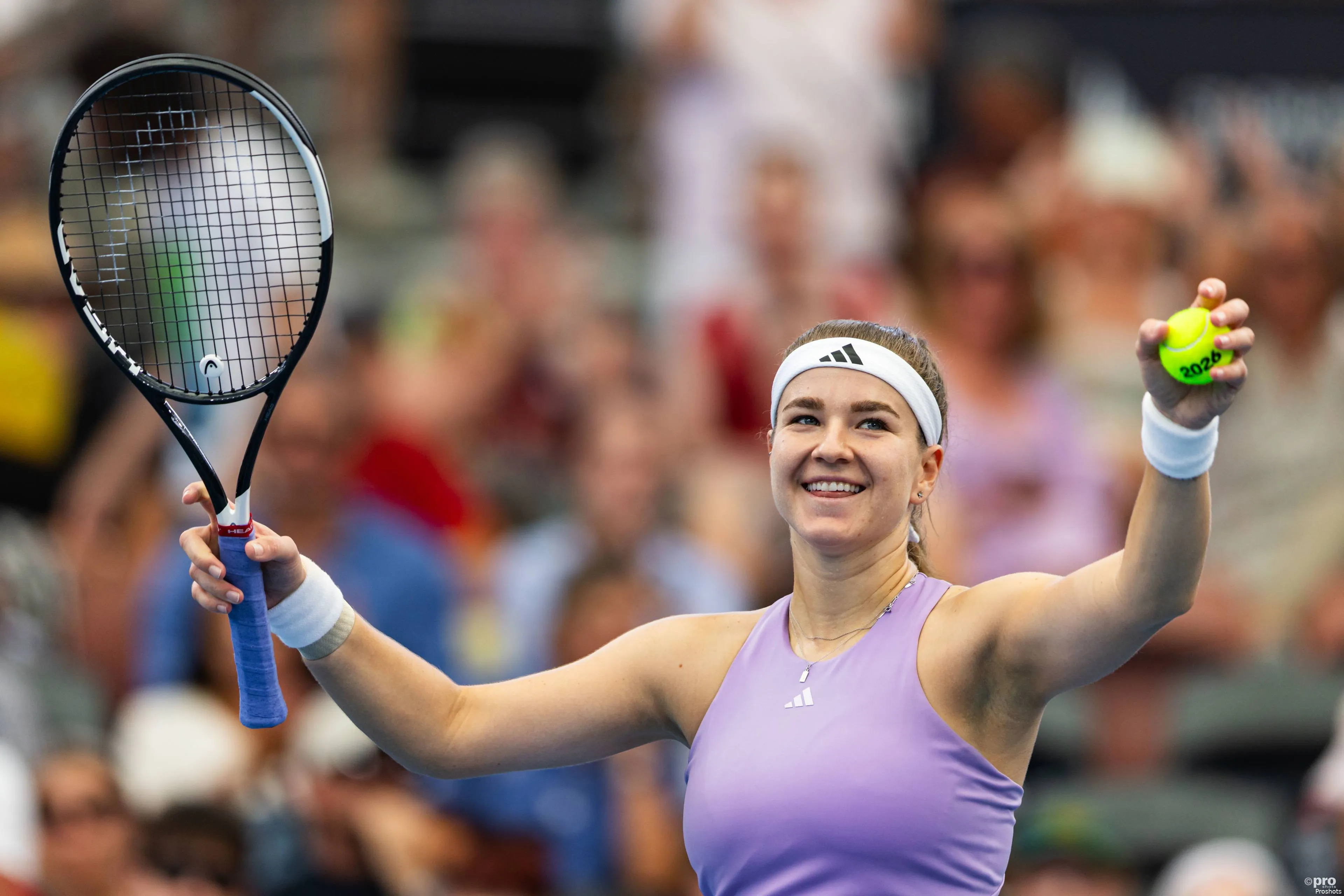 Karolina Muchova raises both hands aloft