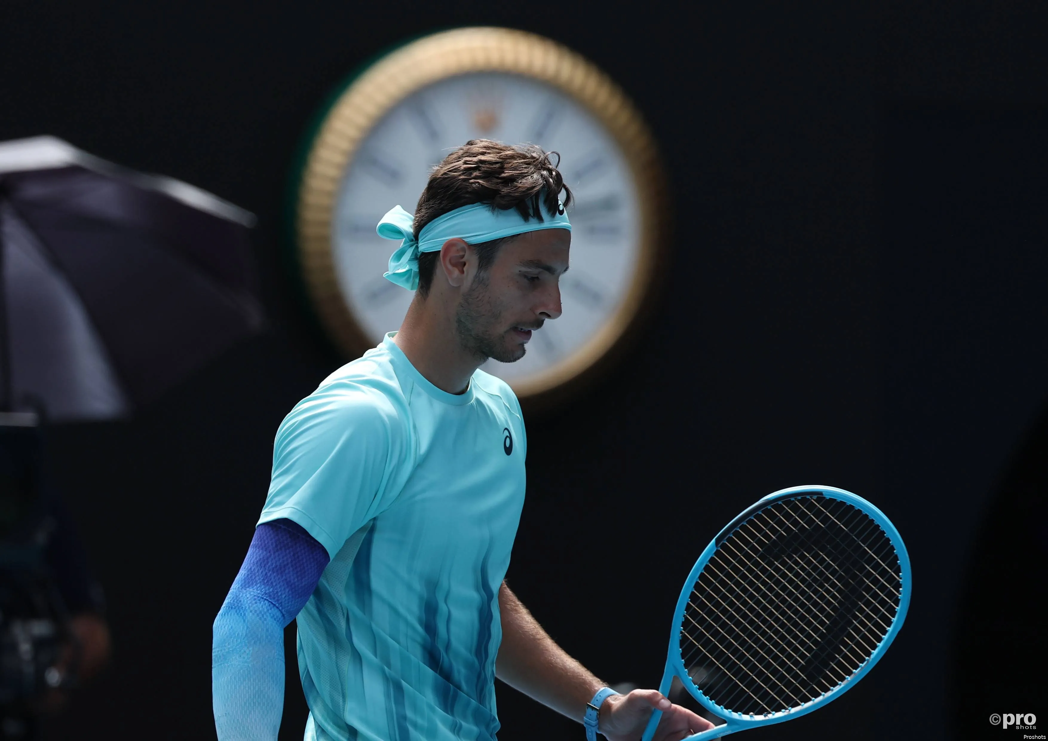 Lorenzo Musetti walks back to the baseline.