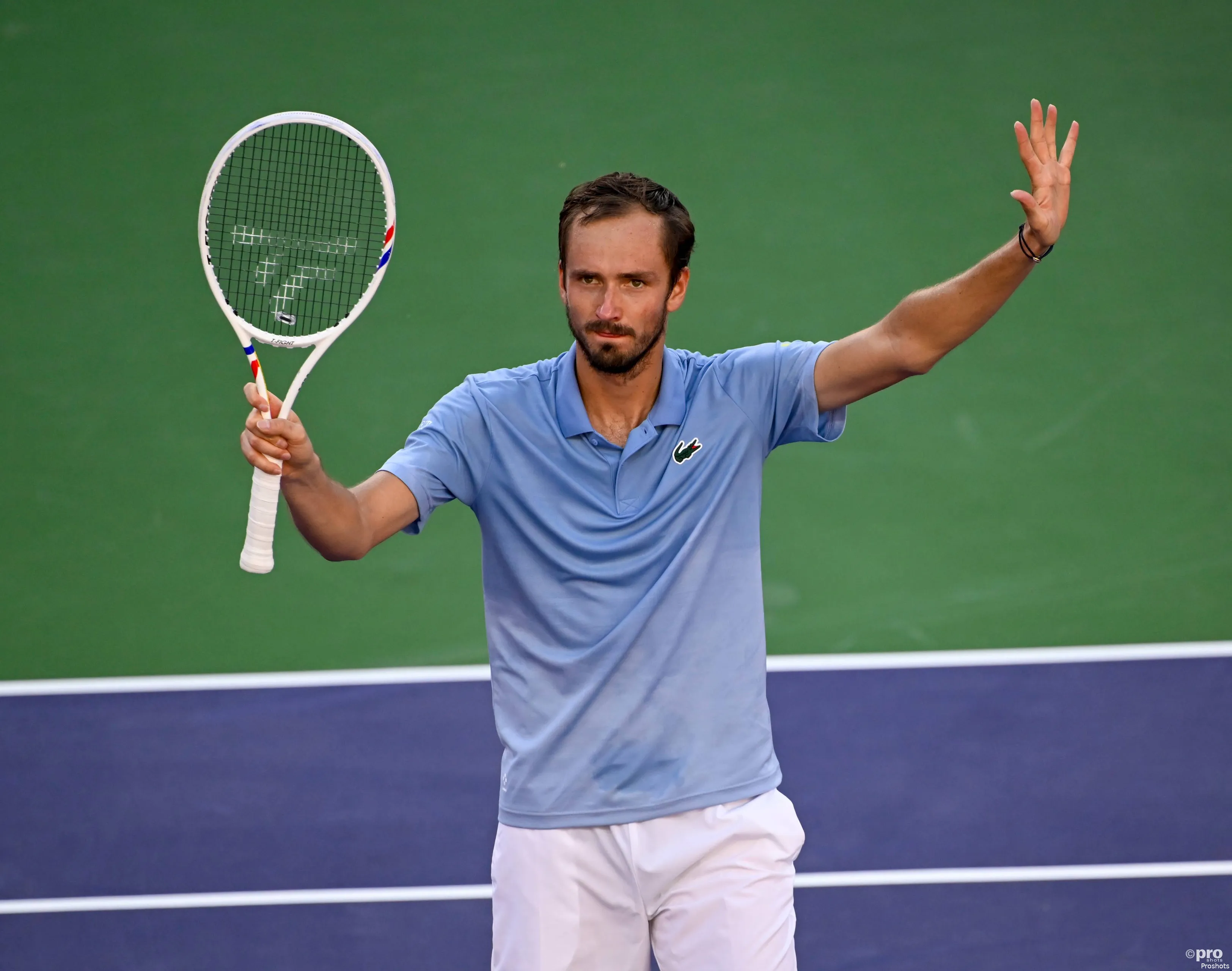 Medvedev waves racquet.