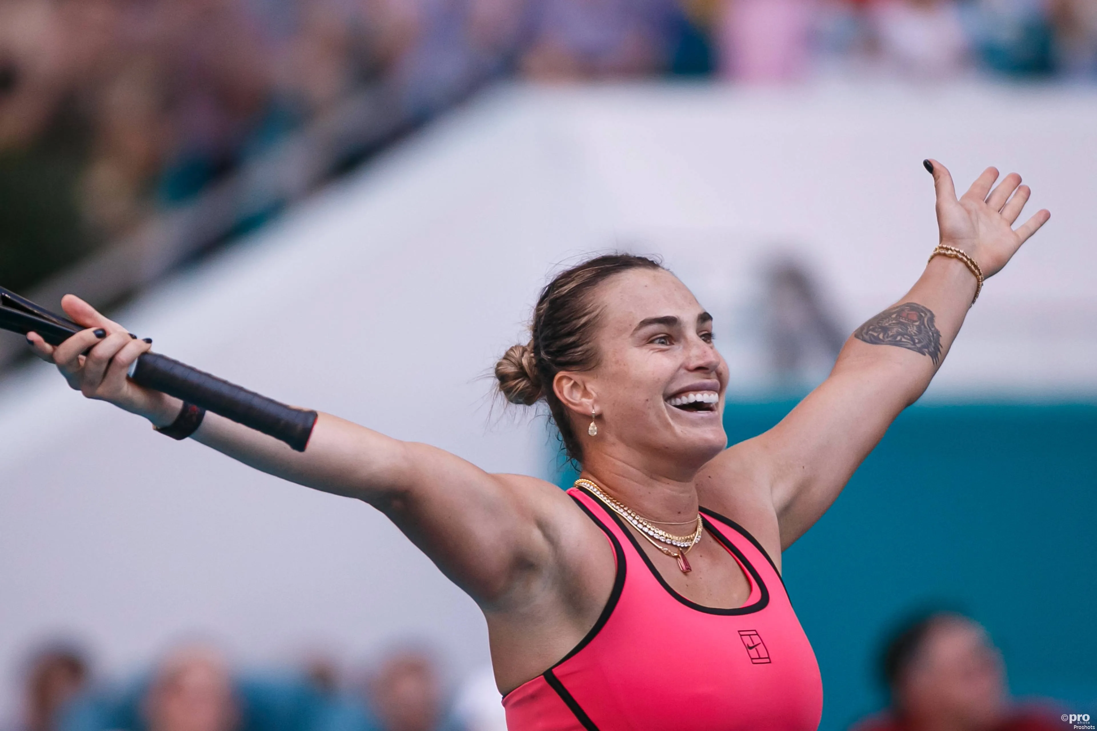 Sabalenka holds arms aloft.