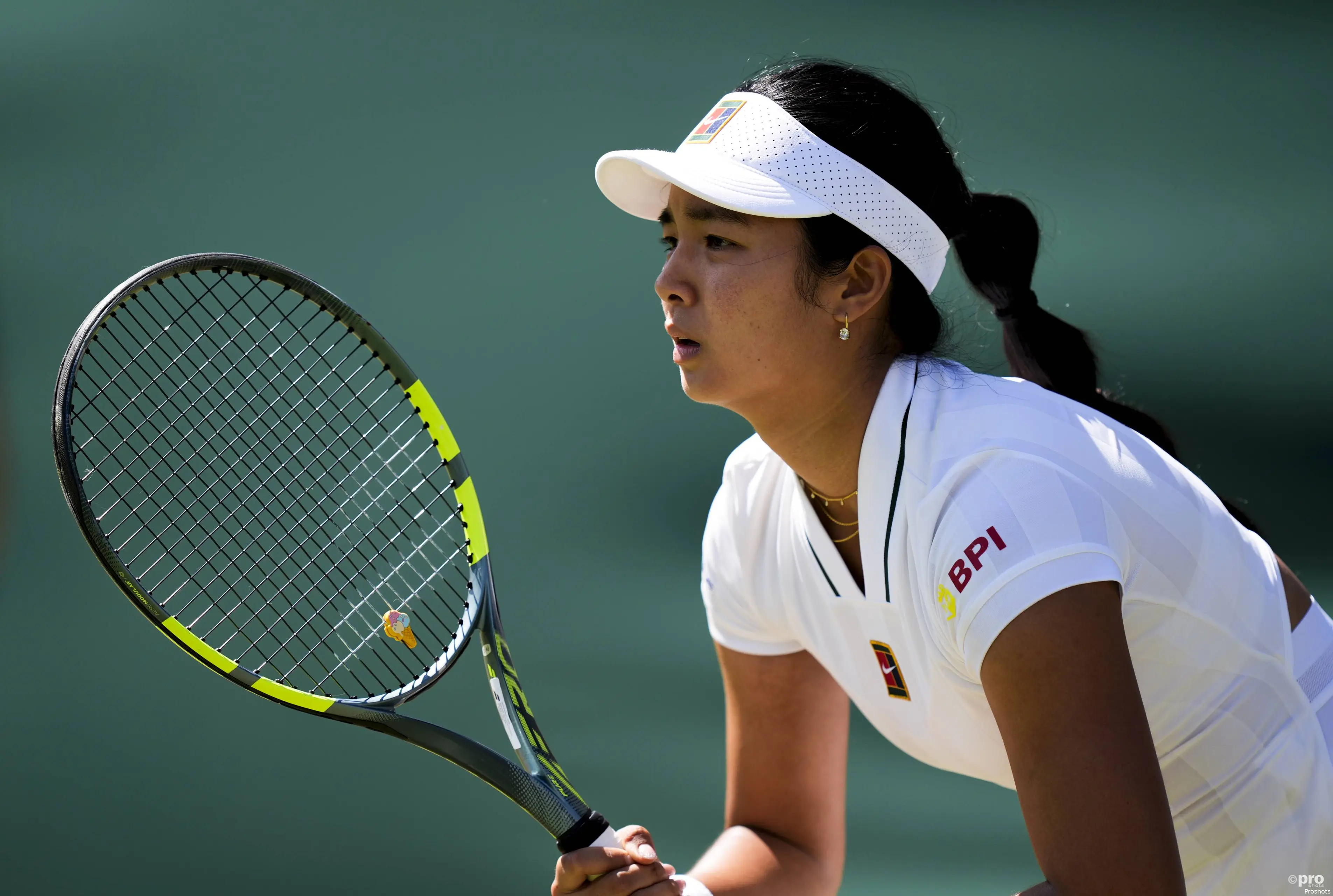 Alexandra Eala holds racquet waiting to return.