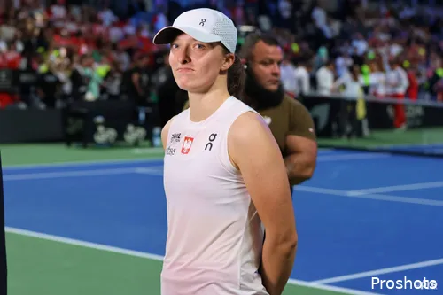 Iga Swiatek poses next to the court during the 2025 BJK Cup