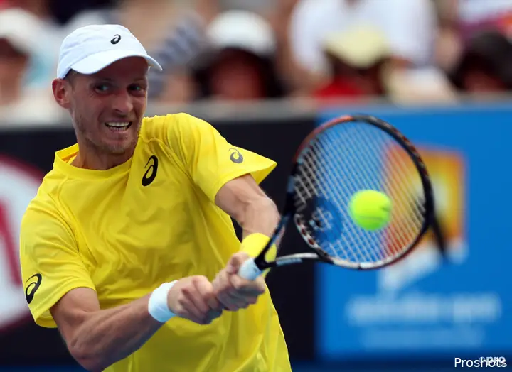 Nikolay Davydenko of Russia returns a shot in the men's singles first round match against Richard Gasquet of France at 2014 Australian Open