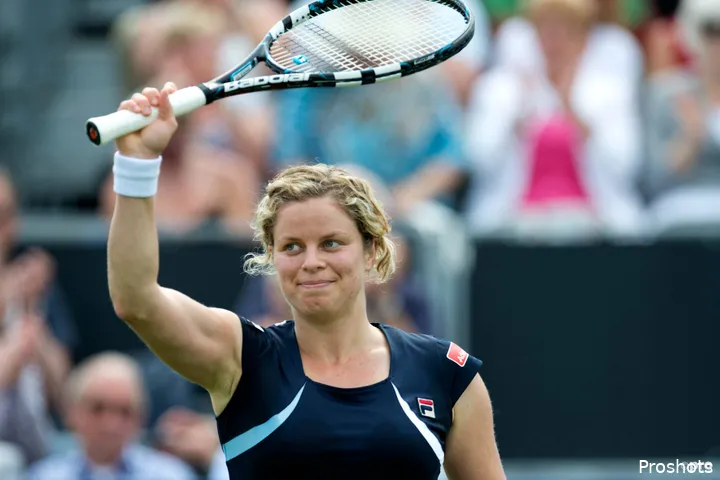 Kim Clijsters waves racquet.