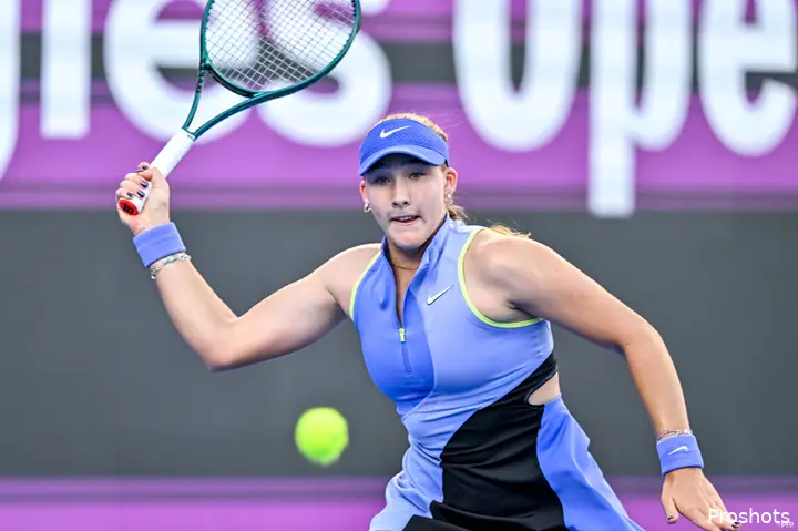 Mirra Andreeva swats return.