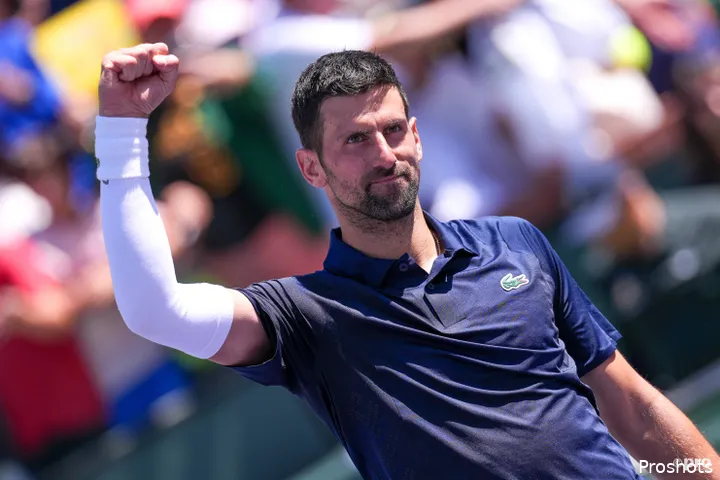 Novak Djokovic raises fist to crowd.